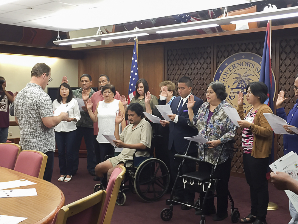 Acting Governor Ray Tenorio (Back facing the camera), swears in new members of the State Rehabilitation Council. 